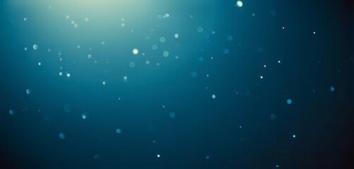 Abstract blue background with blurred dust or light reflective particles.