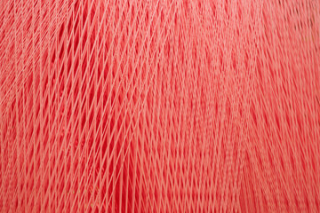 Poster - A red threads and fibers with a pattern of lines and dots as a texture background. The fabric is very thick and has a lot of texture