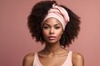 © Graphic Gem Market - Beautiful young afro american woman with pink headband and clean fresh skin, on pink background.