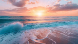 Fototapeta Natura - The horizon comes alive with the warm glow of the sunrise, shimmering across the ocean's surface and highlighting the beach's beautiful textures