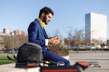 Side view of businessman eating lunch in a work break.