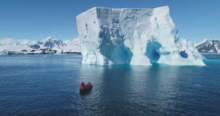 people boat tour expedition to antarctic iceberg. antarctica travel and exploration. arctic winter g