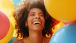 A close-up shot capturing the girl model's laughter, with colorful balloons floating around her against a sunny yellow background.