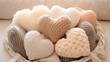 A collection of soft, plush pillows arranged in a heart shape on a cozy baby blanket.