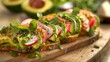 Freshly prepared avocado toast garnished with tomato, radishes, and basil, served on a rustic wooden board