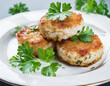 Crab cakes with parsley as an appetizer plate.