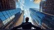 © Alena - Businessman from behind, looking up at towering skyscrapers against a blue sky with clouds.