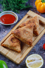 Wall Mural - Fried samosas with vegetable filling, popular Indian snacks.