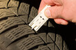 close-up of measuring tread depth of car tire