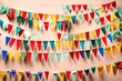 Colorful holiday flags in the form of a garland on the wall. The garland hangs in two rows. Congratulatory background with place for text. Holiday concept