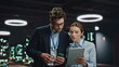© stockbusters - IT engineers working tablet in night data center closeup. Colleagues discussing