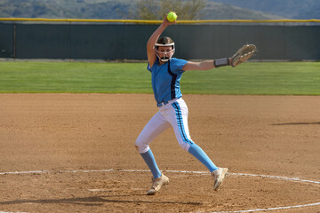 Young female Softball player playing youth sports. Pitcher