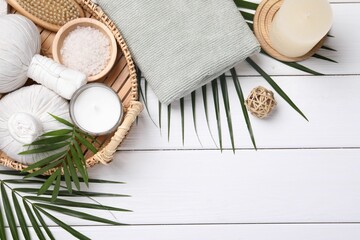 Wall Mural - Flat lay composition with candle and different spa products on white wooden table. Space for text