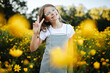 © Maria Manco/Stocksy - Preteen smiles at camera in wildflower field