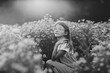© Maria Manco/Stocksy - Preteen smiles at camera in wildflower field