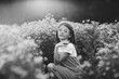 © Maria Manco/Stocksy - Preteen smiles at camera in wildflower field