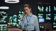 © stockbusters - Computer scientist lady answering cellphone call talking at datacenter closeup.