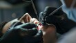 © cff999 - View into a mouth in which a dentist wearing black rubber gloves is carrying out a prophylactic treatment on a patient