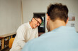 © Studio Firma/Stocksy - Colleagues talking in office