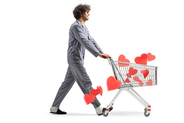 Sticker - Young man in pajamas walking with hearts in a shopping cart