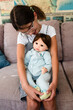 © Maria Manco/Stocksy - little girl holds baby doll