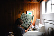 © Maria Manco/Stocksy - Tween loads washing machine with laundry