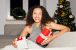 © Artem Podrez/Stocksy - Portrait  woman in a shiny dress happy received christmas gift. Flash