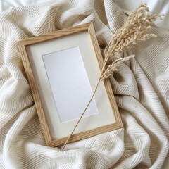 Sticker - wooden blank photo frame mockup with white interior laying on a blanket white background 