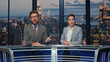© stockbusters - Positive news readers talking live tv newscast in night channel studio closeup
