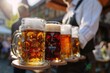 A man is holding a tray of beer glasses, including a glass of beer with a green coaster. Oktoberfest Concept