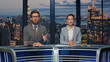 © stockbusters - Charismatic tv reporters talking evening breaking news closeup. Hosts discussing