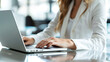 © Insight Lens - female person or businesswoman is typing on a laptop, close up laptop and hands