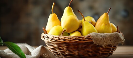 Poster - A wooden table holds a basket filled with yellow pears, showcasing the beauty of terrestrial plants and their delicious fruits