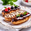 French eclairs with chocolate glaze,fruit on white plate, marble background,close up