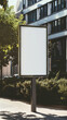 A white sign is placed neatly on the side of a sidewalk, with a clean blank screen for potential messages or information to be displayed.