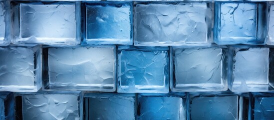 Wall Mural - A close up of a wall made of azure ice cubes, creating a fluid and symmetrical pattern. The electric blue color reflects in the transparent material, resembling a work of art