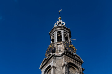 Poster - Fragment of Amsterdam Mint Tower (or Munttoren, 1620) at Muntplein square near flower market. Munttoren was originally part of gate in Amsterdam's medieval city wall. Amsterdam, the Netherlands.