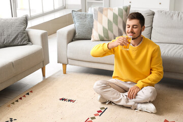 Poster - Young man drinking juice at home