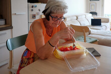 Woman Eating Watermelon At Home Wile Sitting On The Table