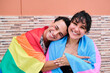 © J Esteban Berrío/Stocksy - Smiling friends in fraternal embrace