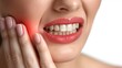 © MMerellinn - A woman holds her cheek while suffering from a toothache, depicting the discomfort and pain experienced during dental issues, emphasizing the need for oral health care and treatment