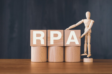 Poster - There is wood cube with the word RPA. It is an abbreviation for Robotic Process Automation as eye-catching image.