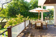© Raymond Forbes LLC/Stocksy - Late Summer wood house outdoor porch furniture with Hydrangea summer