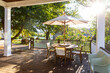 © Raymond Forbes LLC/Stocksy - Late Summer wood house outdoor porch furniture with Hydrangea backlit