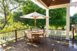 © Raymond Forbes LLC/Stocksy - Late Summer wood house outdoor porch table  with Hydrangea flowers