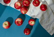 © Anna Artemenko/Stocksy - red apples on a blue background