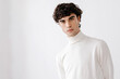 © Tania Cervian/Stocksy - Portrait of serious young man in white cloth looking at camera