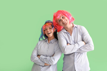 Sticker - Business colleagues in funny wigs on green background. April Fools' Day celebration