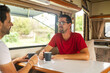 © Lupe Rodríguez/Stocksy - gay couple drinking coffee inside their motorhome