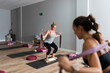 © Raul Navarro/Stocksy - women exercising in yoga class.